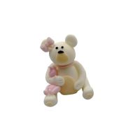 White teddy bear with a pink bow