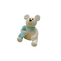A white teddy bear with a blue bow