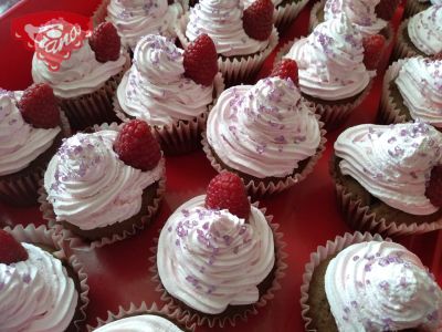 Gluten-free and dairy-free cupcakes with cherry and raspberry whipped cream