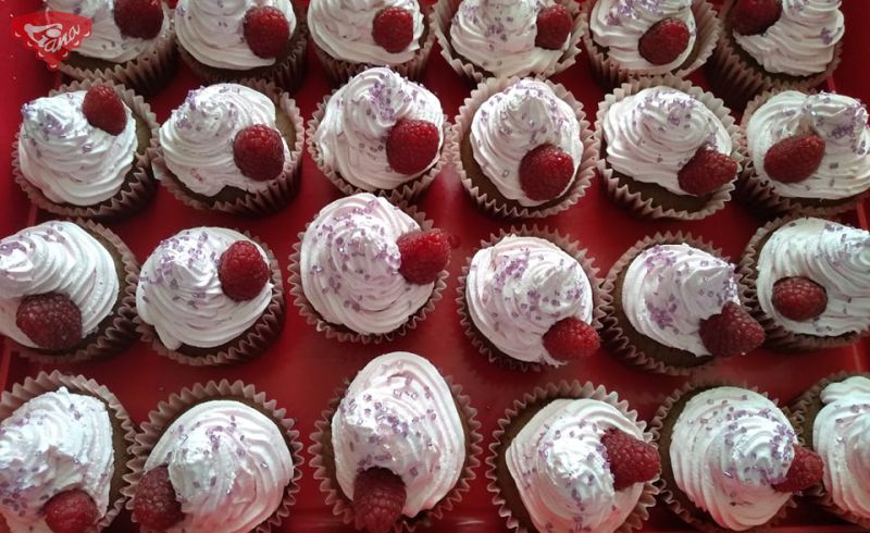 Gluten-free and dairy-free cupcake with cherry and raspberry whipped cream